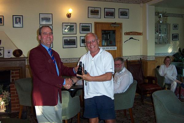 Brian Cudby awards John Tuffen the most sought-after prize in shooting. Beer.